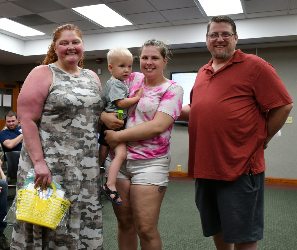 Richard Linder, right, and his daughter Lexus, pictured center,  present Tonya Reynolds of Franklin Preschool, (far left) with a thank you gift for her assistance in helping Lexus and her two young sons following a car accident.  The presentation was made during the May 10, 2022 school board meeting.