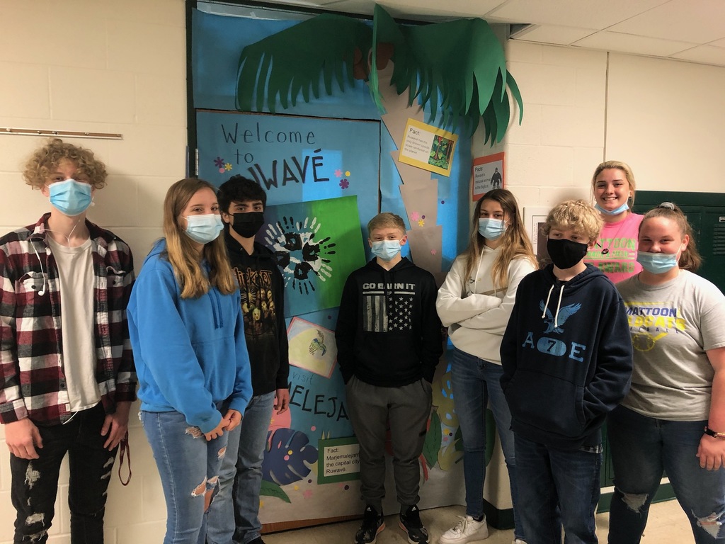 Students from Mrs. Ruholl's Wave Time stand next to the door they decorated for the Wave Time Olympics.
