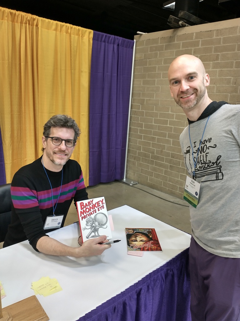 Mr. Wheeler meets author Brian Selznick who is autographing a copy of Baby Monkey, Private Eye for the classroom library