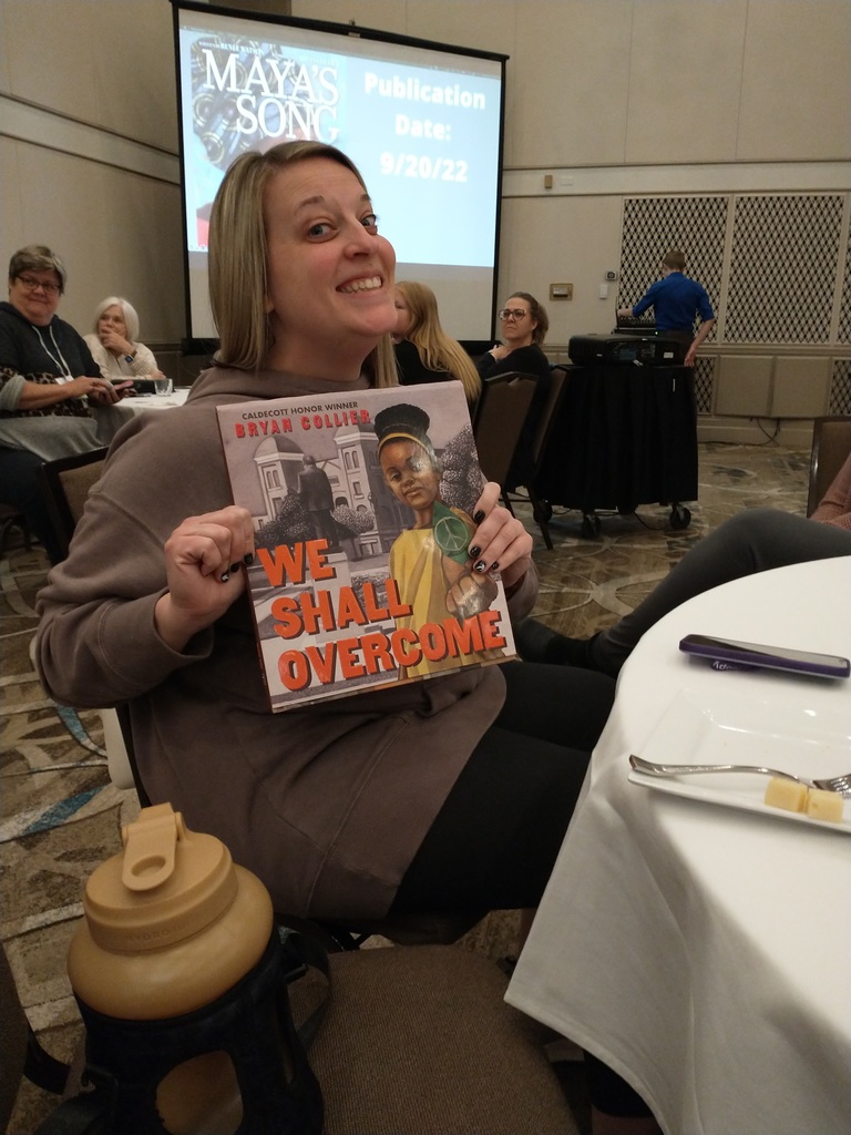  Miss Weber displays a book John Schu gave her during his Wednesday night presentation at the Illinois  Reading Conference